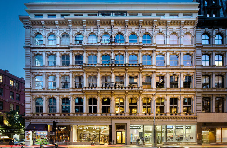 A building with many windows on the side of it.