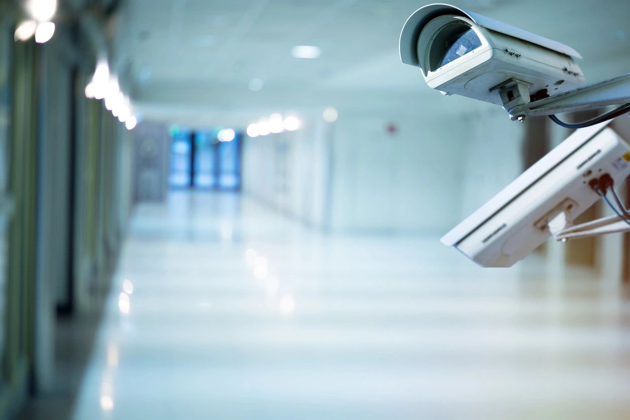 A camera is mounted to the side of a building.