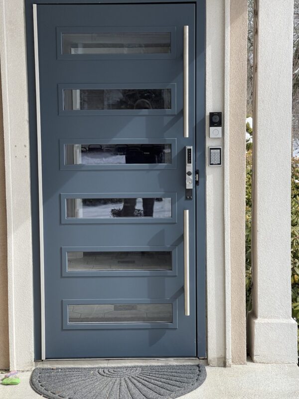 A door with four panels and one glass pane.